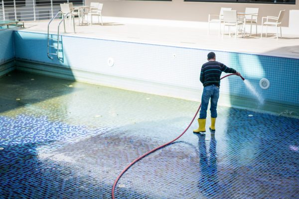 A man cleaning pool